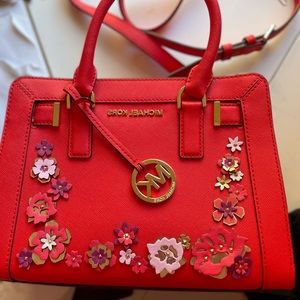 Michael Kors chili/flame handbags with 3D flowers.